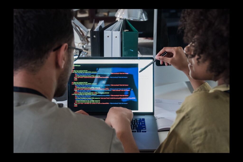 Product team reviewing software code together during development