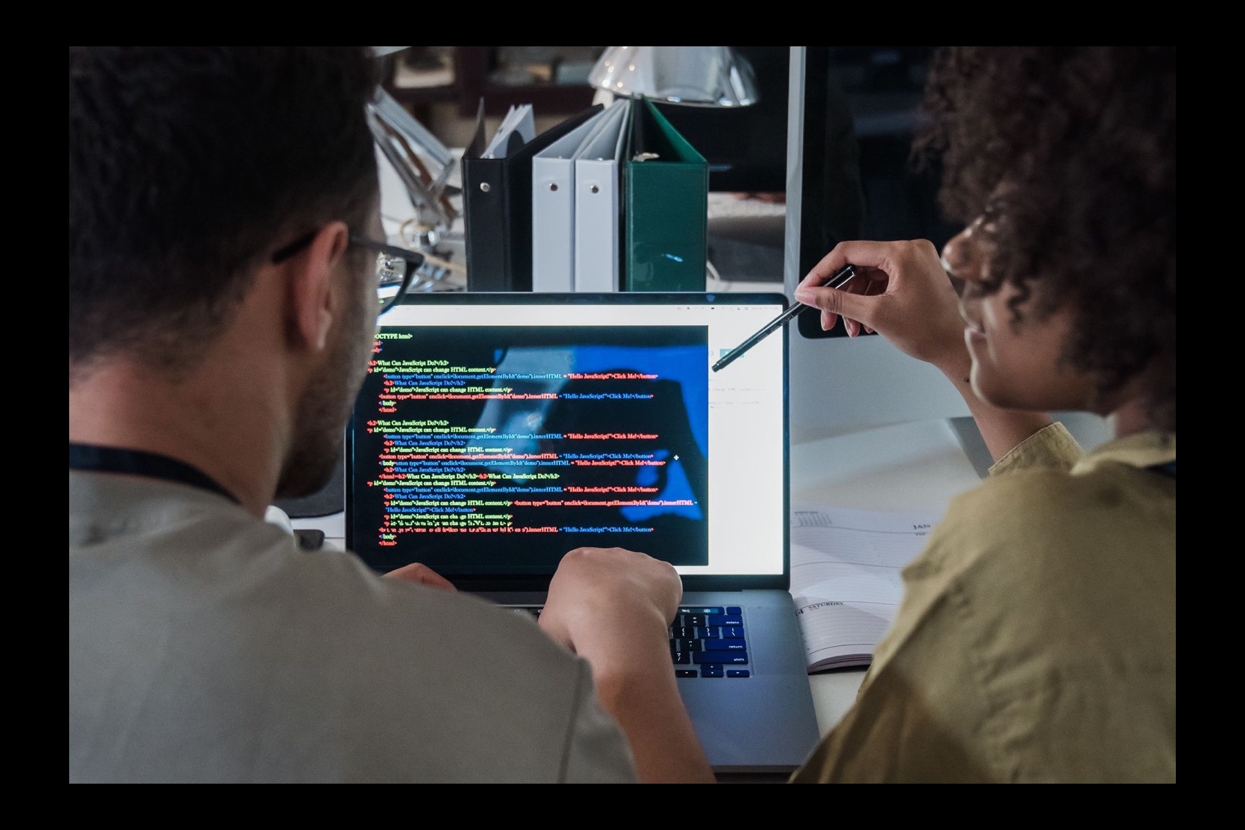 Product team reviewing software code together during development